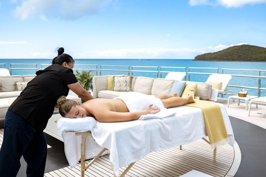 A massage on the sun deck of a Burgess charter yacht