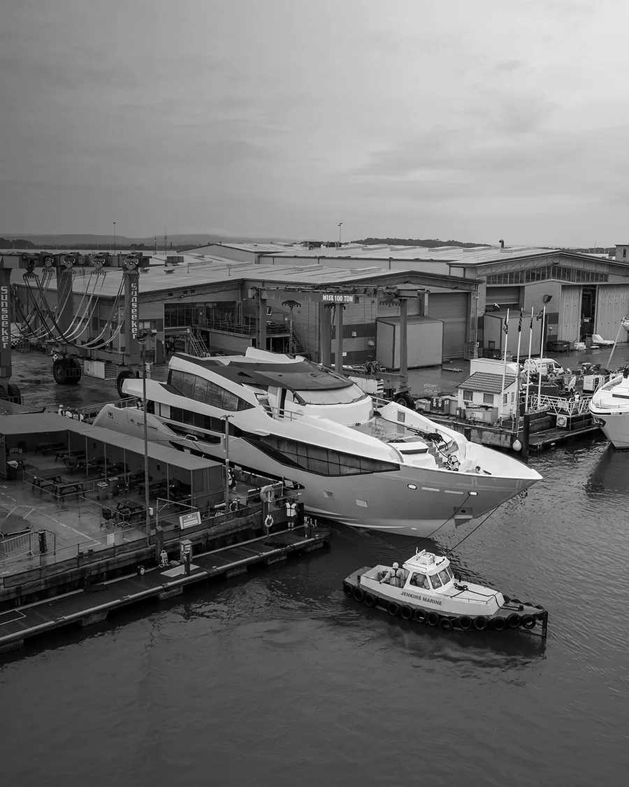 The Sunseeker 134 Superyacht alongside at the yard, seen from above with a workboat